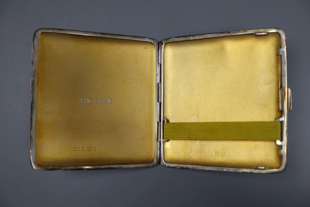 Three assorted mid 20th century silver engine turned cigarette cases, largest 16.8cm, gross 18oz.